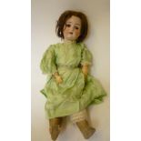 A Kestner bisque head girl doll with brown glass sleeping eyes, open mouth and teeth, brown mohair