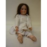 A Unis (France) bisque head girl character doll with blue glass flirty eyes, open mouth and teeth,