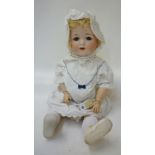 An Edmund Edelmann bisque head girl toddler doll with blue glass sleeping eyes, open mouth, blonde