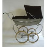 A Silver Cross doll's pram, c.1960, coach built with lined dove grey metal body, chromium plated