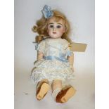 A Jumeau bisque head girl doll with fixed blue paperweight glass eyes, closed mouth, pierced ears,