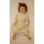 A Max Handwerck bisque head girl doll with brown glass sleeping eyes, open mouth and teeth, brown
