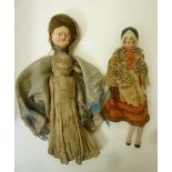 A late 19th century carved wood doll with painted face, mohair wig and original white cotton dress