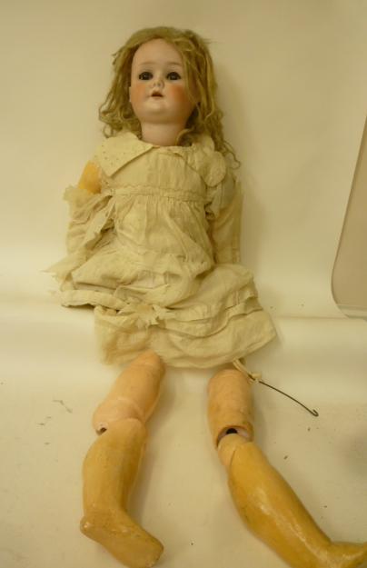 A Schoenhaur & Hoffmeister bisque head girl doll with brown glass sleeping eyes, open mouth and