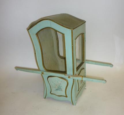 A doll's Sedan chair, painted wood construction, glazed, floral painted panels, 16" high, 17" long