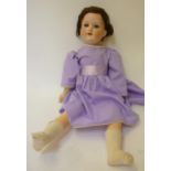 An Armand Marseille bisque head girl doll with blue glass sleeping eyes, open mouth and teeth, brown