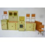 A Welfreeze tinplate doll's refrigerator and eleven matching items of kitchen units and furniture,