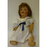 An Armand Marseille bisque head character doll with blue glass sleeping eyes, open mouth and