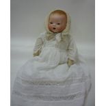 A Hermann Von Berg bisque head baby doll with blue glass sleeping eyes, open mouth, trembling