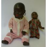 An Ernst Heubach bisque head black baby doll with brown glass sleeping eyes, closed mouth, moulded