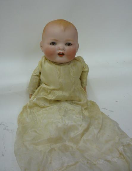 An Armand Marseille "Baby Gloria" bisque head baby character doll with brown glass sleeping eyes,