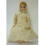 A Simon & Halbig bisque head girl doll with brown glass sleeping eyes, open mouth and teeth, pierced