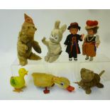 A collection of seven clockwork novelty toys, comprising Bavarian boy and girl, 7" high, monkey