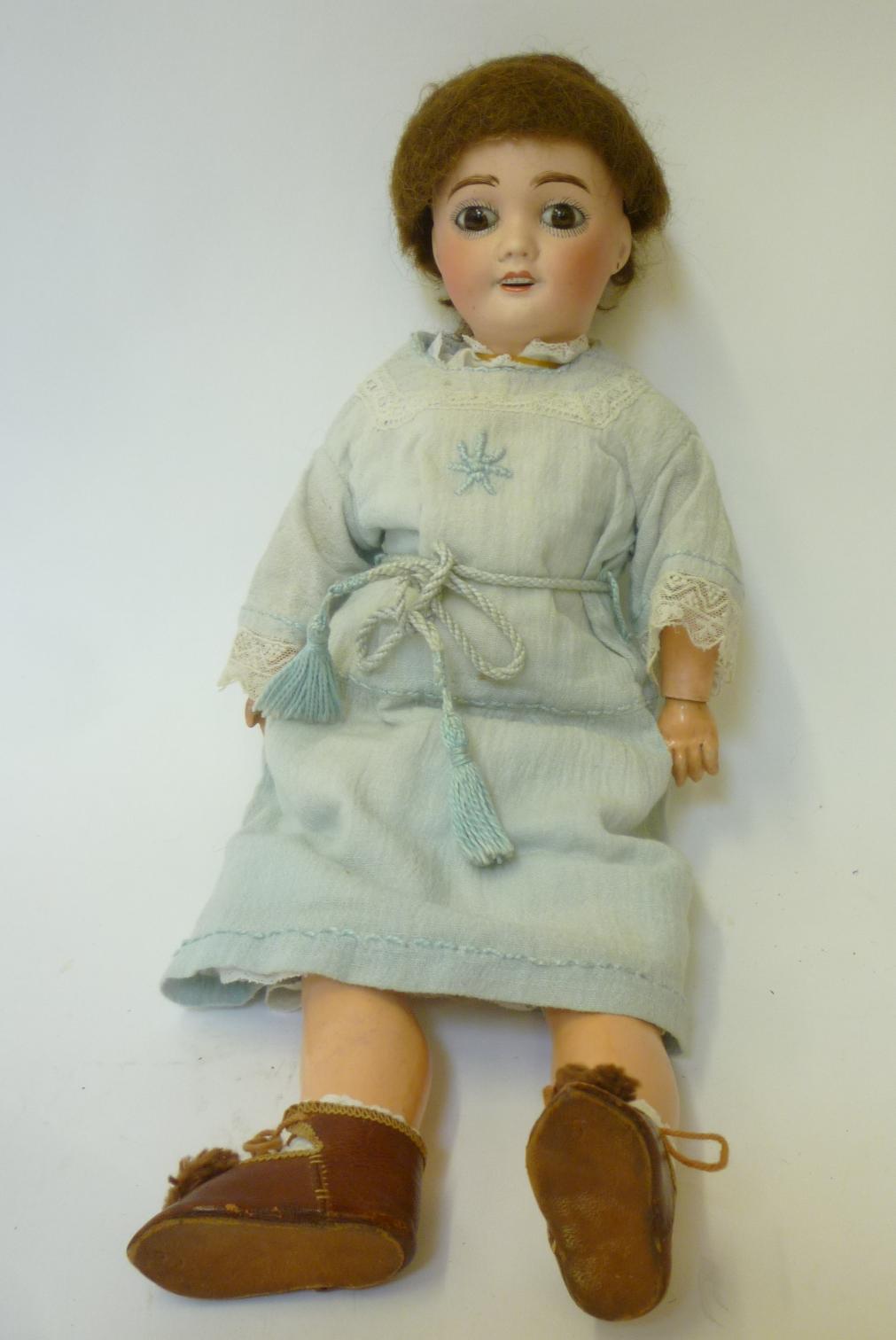 A French "Cherie" bisque head girl doll with fixed brown glass eyes, open mouth and teeth, pierced