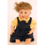 A Kammer & Reinhardt bisque head character boy doll with brown glass sleeping eyes, open mouth,