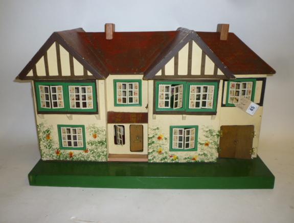 A Triang dolls' house, painted wood construction with pitched and gabled roof, opening front,