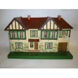 A Triang dolls' house, painted wood construction with pitched and gabled roof, opening front,