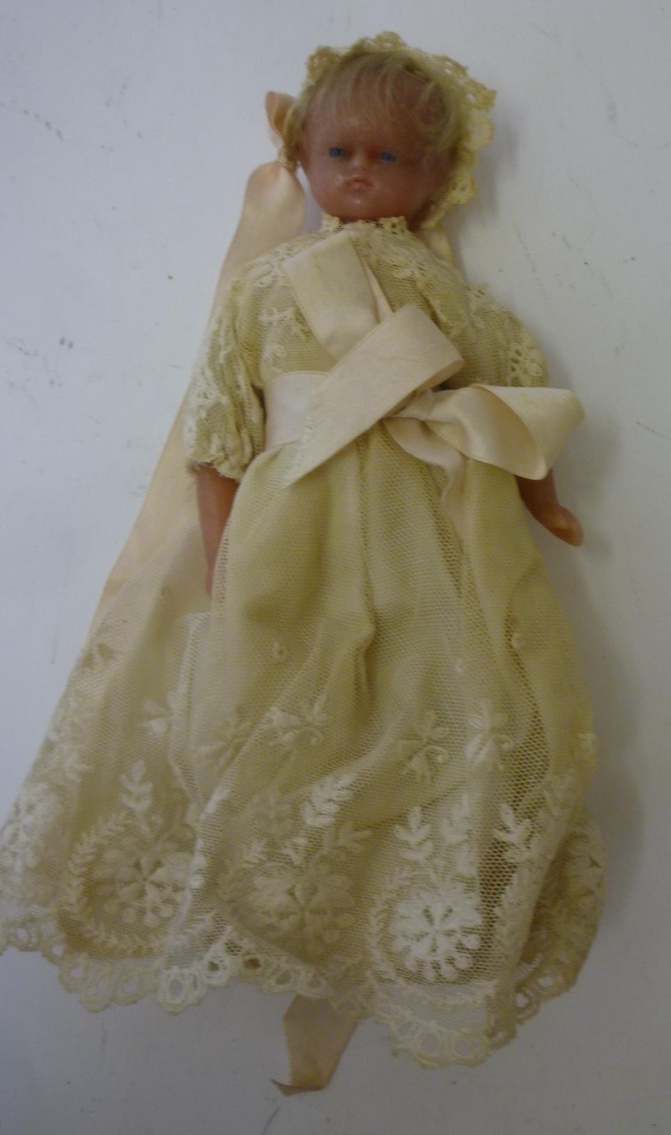 A poured wax shoulder head doll, c.1880, with inset blue glass eyes, blonde mohair wig, stuffed