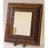 A WILLIAM & MARY WALNUT OYSTER VENEERED SMALL WALL MIRROR, the later bevelled oblong plate within