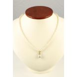 A CULTURED PEARL NECKLACE, centred by a small pendant open back collet set with three small diamonds