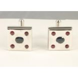 A PAIR OF MODERN SILVER CUFFLINKS, the square panels with black enamelled sides centrally gypsy