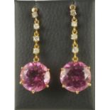 A PAIR OF PINK TOPAZ AND DIAMOND EAR PENDANTS, the circular facet cut topaz claw set to an 18kt gold