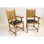 A PAIR OF OAK ELBOW CHAIRS by Colin Almack "Beaverman", the solid back with arched top rail over