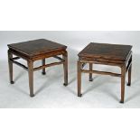 A PAIR OF CHINESE JANU (ELM) (?) URN STANDS of low square form, the flush field panel top and