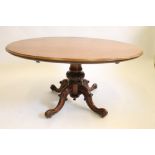 A VICTORIAN MAHOGANY LOO TABLE, the oval tip up top with moulded edge and plain frieze, turned
