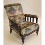 A VICTORIAN WALNUT FRAMED ARMCHAIR upholstered in a chequered weave, scrolled back, padded arms on