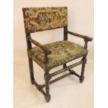 A FLEMISH WALNUT ARMCHAIR, late 17th century, the padded back and overstuffed seat in gros point,