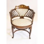 AN EDWARDIAN MAHOGANY AND INLAID BOUDOIR CHAIR, upholstered in a pale green floral weave, padded