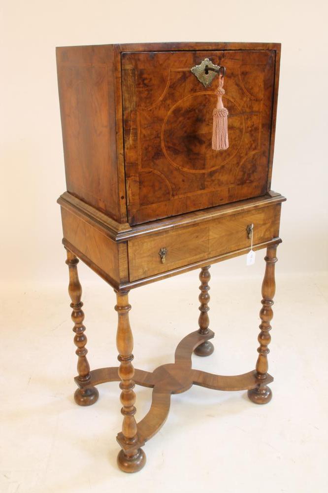 A WILLIAM & MARY WALNUT AND FEATHER BANDED CABINET on later stand, c.1900, the oblong cabinet with