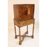 A WILLIAM & MARY WALNUT AND FEATHER BANDED CABINET on later stand, c.1900, the oblong cabinet with