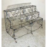 A VICTORIAN WIREWORK PLANT STAND of three tier oblong form with arched back, the whole worked in a
