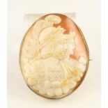 A VICTORIAN SHELL CAMEO BROOCH of oval form, carved in relief with a Roman centurion wearing a