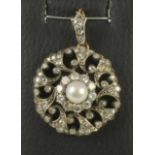 A VICTORIAN DIAMOND AND PEARL FLOWERHEAD PENDANT, the central pearl within a border of ten open back