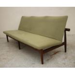 A DANISH TEAK FRAMED THREE SEATER SOFA upholstered in a pale green weave, shaped back and