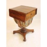 A VICTORIAN ROSEWOOD WORK TABLE, the rounded oblong top with twin flaps, frieze drawer with turned