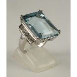 AN ART DECO STYLE AQUAMARINE AND DIAMOND COCKTAIL RING, the emerald cut aquamarine claw set