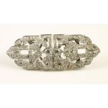 AN ART DECO DIAMOND CLIP BROOCH of shaped oblong form, the geometric strapwork pave set with