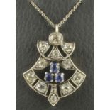 AN ART DECO DIAMOND AND SAPPHIRE PENDANT of stylised open anthemion form centred by three facet