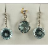 A PAIR OF BLUE TOPAZ DROP EARRINGS AND MATCHING PENDANT, the circular facet cut baby blue stones