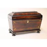 A REGENCY ROSEWOOD TEA CHEST of sarcophagus form with brass stringing and reel edging, hinged lid