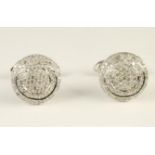 A PAIR OF DIAMOND CUFFLINKS, the domed circular plaques all over pave set with small brilliant cut