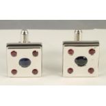 A PAIR OF MODERN SILVER CUFFLINKS, the square panels with black enamelled sides centrally gypsy