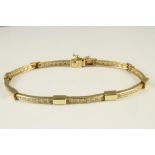 AN ITALIAN 14K GOLD AND DIAMOND BRACELET comprising eight slightly convex slim panels each