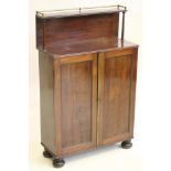 A SMALL REGENCY MAHOGANY CHIFFONIER, the raised shelved back with gilded brass gallery surmount on