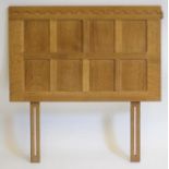 AN OAK SINGLE DIVAN HEADBOARD by Robert "Mouseman" Thompson, the straight half penny moulded crest