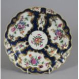 A FIRST PERIOD WORCESTER PORCELAIN PLATE, c.1770-75, of shaped circular form, painted in